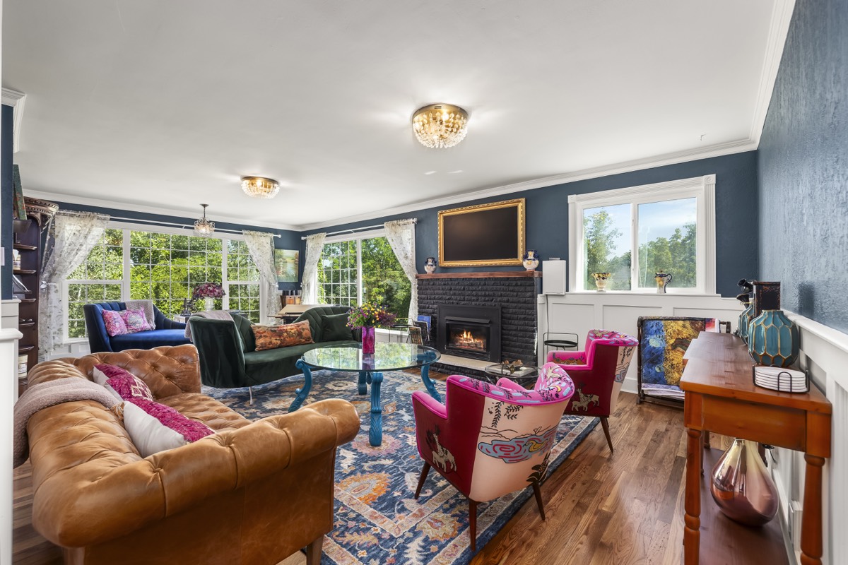 A boldly styled living room with jewel-toned furniture designed by Vanik